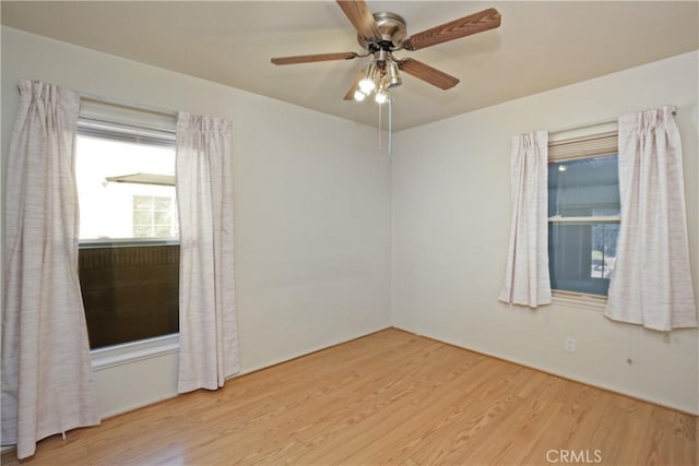 empty room with light hardwood / wood-style flooring and ceiling fan