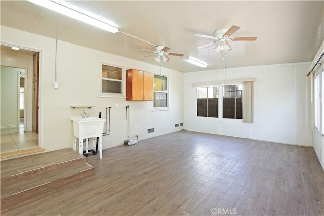 interior space with hardwood / wood-style flooring, sink, and ceiling fan