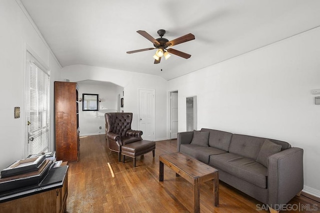 living room featuring hardwood / wood-style flooring, vaulted ceiling, and ceiling fan