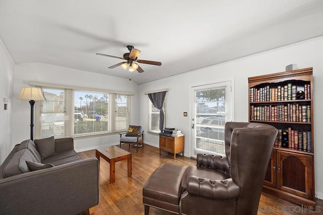 living room with ceiling fan and dark hardwood / wood-style flooring