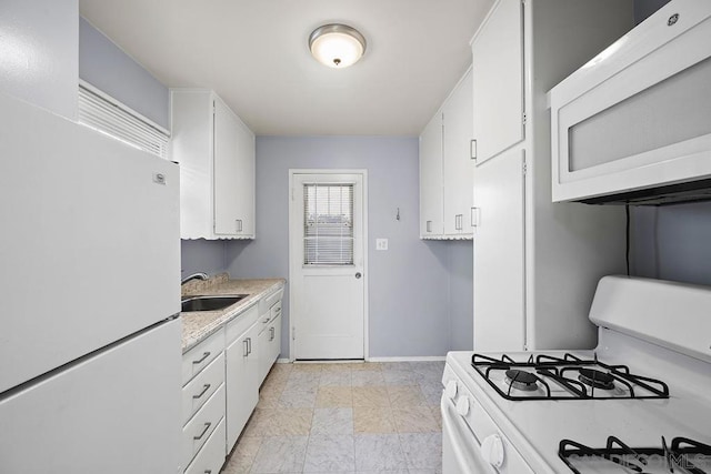 kitchen with white cabinetry, sink, and white appliances