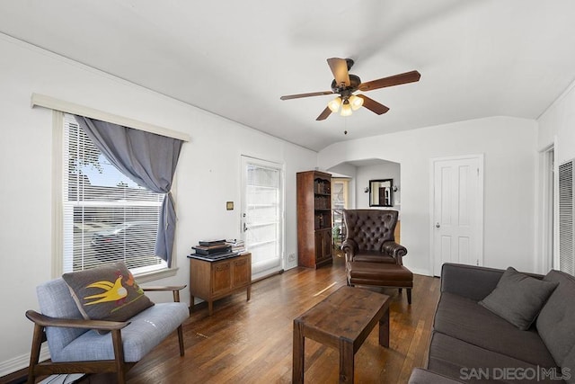 living room featuring ceiling fan, plenty of natural light, and dark hardwood / wood-style flooring