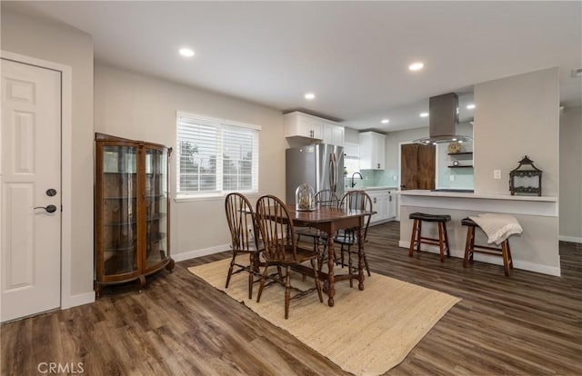 dining room featuring dark wood-type flooring and sink