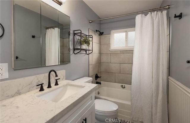 full bathroom with vanity, shower / bath combination with curtain, and toilet