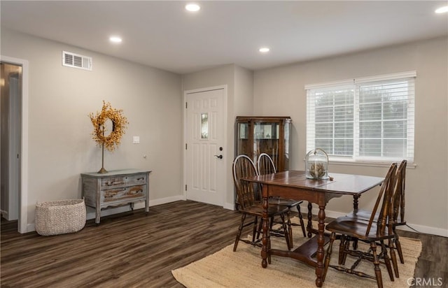 dining area featuring dark wood-type flooring