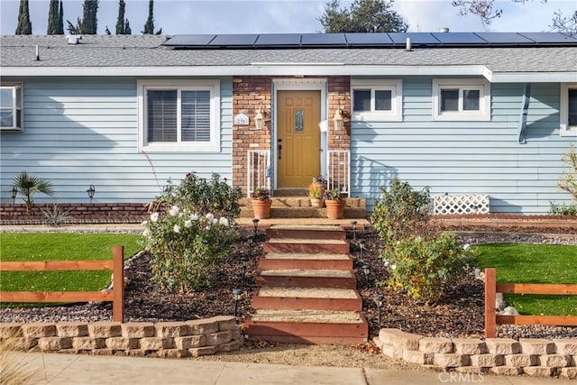 view of exterior entry featuring solar panels