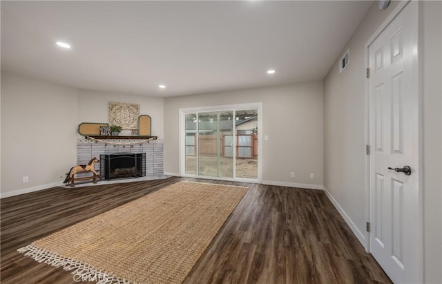 unfurnished living room with dark hardwood / wood-style floors and a fireplace