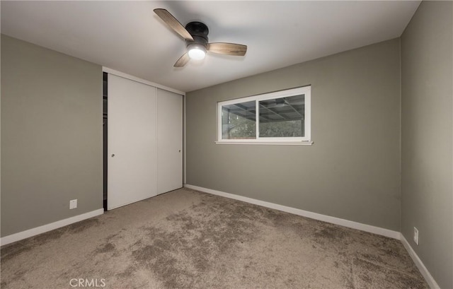 interior space featuring a closet, ceiling fan, and carpet