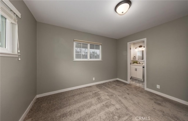 unfurnished bedroom with light colored carpet and ensuite bathroom