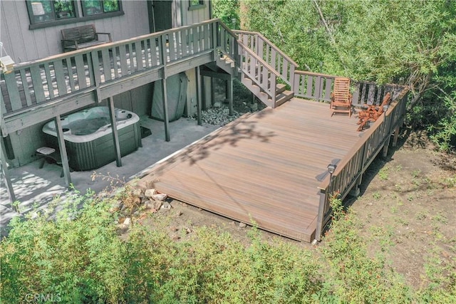 deck featuring a hot tub, a patio, and central AC