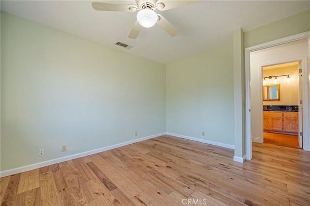 unfurnished bedroom with a ceiling fan, light wood-style flooring, visible vents, and baseboards