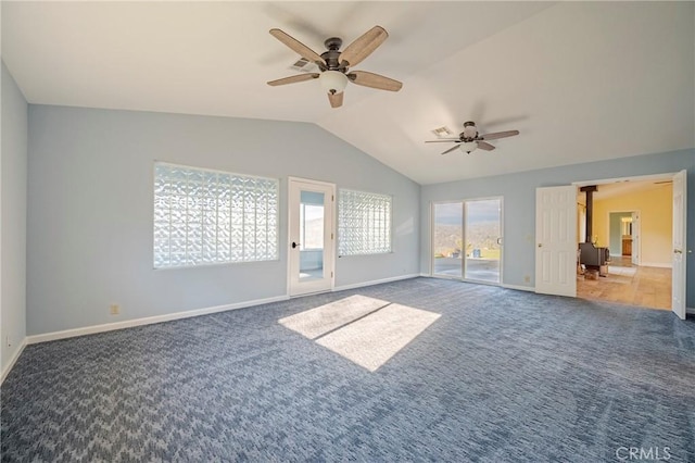unfurnished living room with ceiling fan, carpet, baseboards, and lofted ceiling