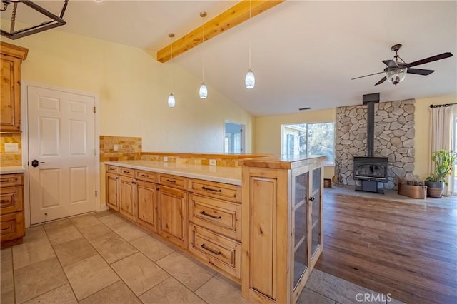 kitchen with pendant lighting, open floor plan, light countertops, and a peninsula