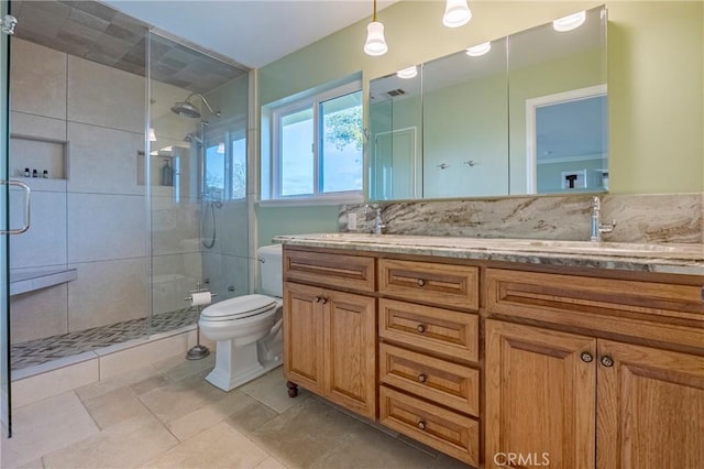 full bathroom with a stall shower, visible vents, vanity, and toilet