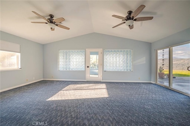 carpeted empty room featuring baseboards, a ceiling fan, and vaulted ceiling