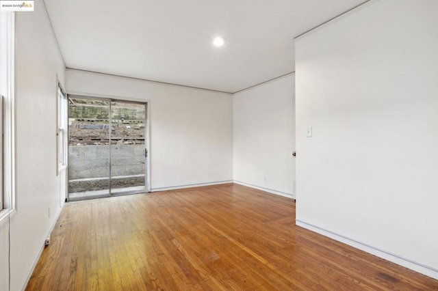 spare room with hardwood / wood-style flooring