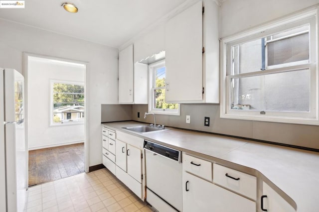 kitchen featuring white appliances, sink, and white cabinets