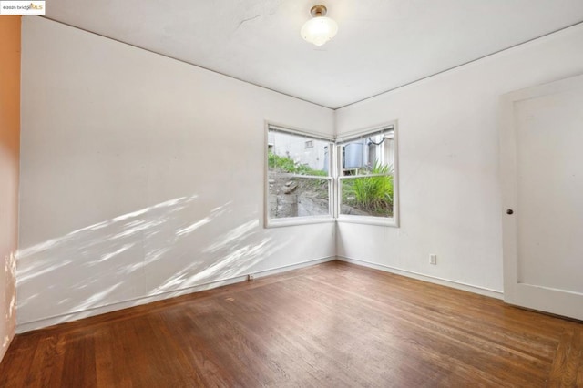 empty room featuring wood-type flooring