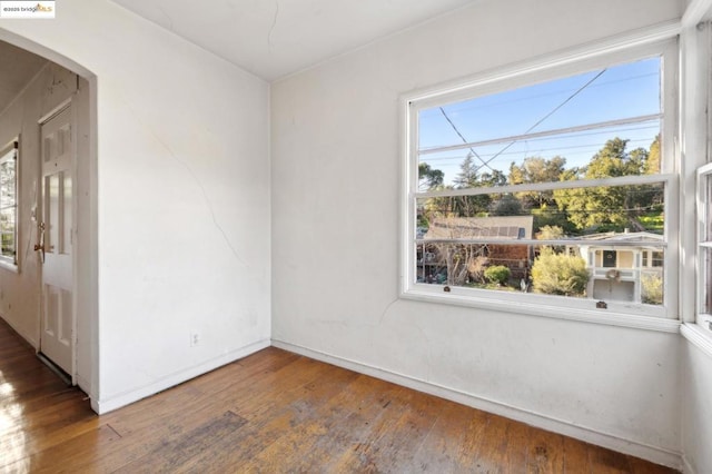 spare room with dark hardwood / wood-style flooring