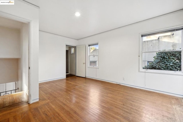 unfurnished room with hardwood / wood-style floors