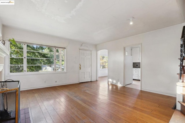 unfurnished living room featuring light wood-type flooring