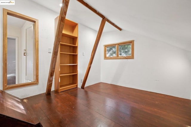 bonus room with lofted ceiling, built in shelves, and dark hardwood / wood-style floors