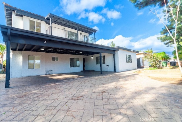 back of property with a balcony