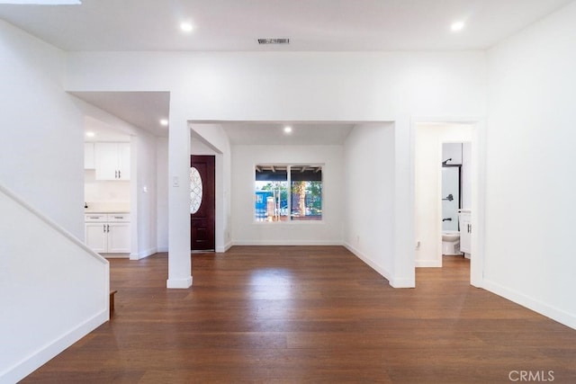 unfurnished living room featuring dark hardwood / wood-style flooring