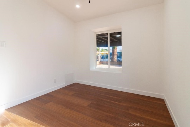 spare room featuring dark wood-type flooring