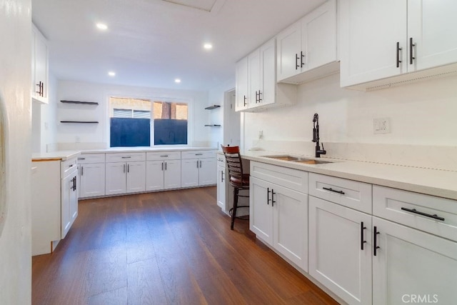 kitchen featuring sink, white cabinets, and dark hardwood / wood-style flooring