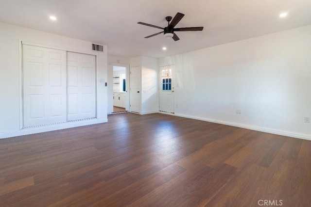 interior space with dark wood-type flooring and ceiling fan