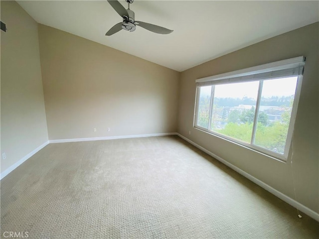 carpeted spare room with ceiling fan and lofted ceiling