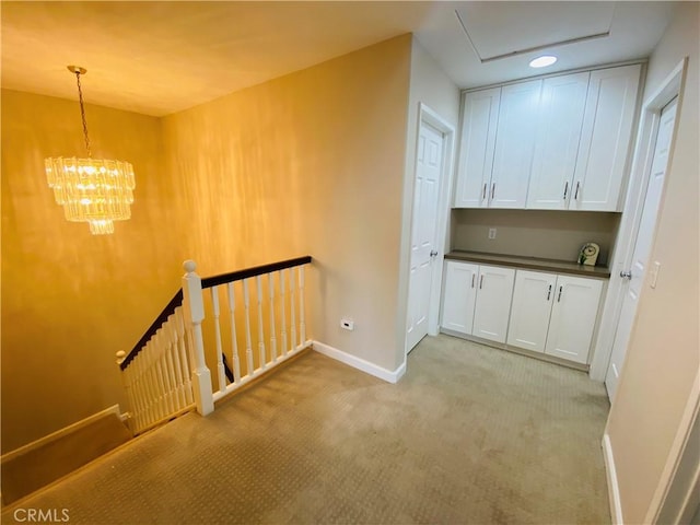 interior space with light carpet and an inviting chandelier