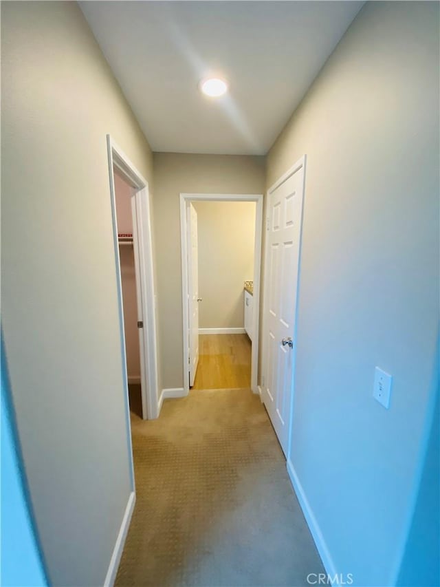 corridor featuring light colored carpet