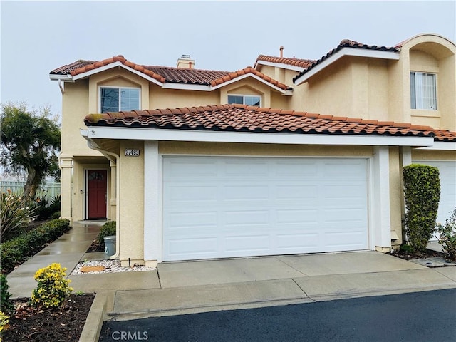 mediterranean / spanish-style home featuring a garage