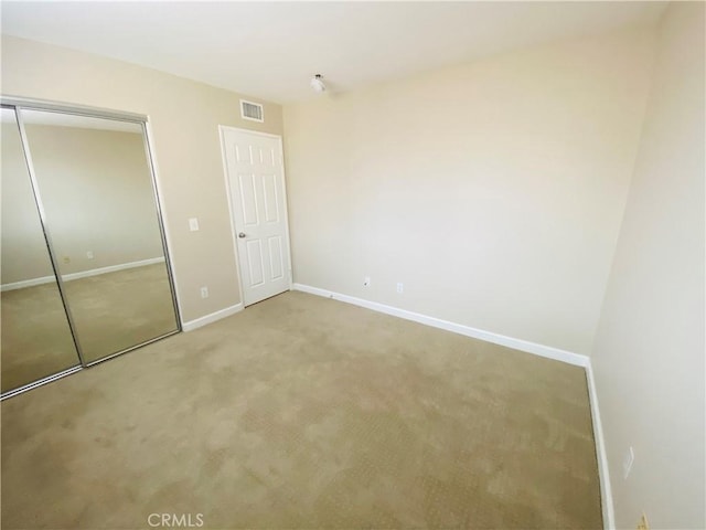 unfurnished bedroom with a closet and carpet flooring