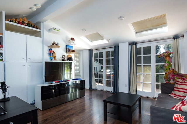 living room featuring dark hardwood / wood-style floors and vaulted ceiling