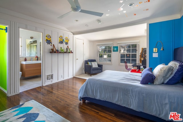 bedroom with lofted ceiling, dark hardwood / wood-style floors, connected bathroom, and ceiling fan