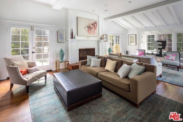 living room featuring dark hardwood / wood-style floors, lofted ceiling with beams, french doors, and a healthy amount of sunlight