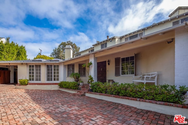 view of front of property featuring a patio and french doors