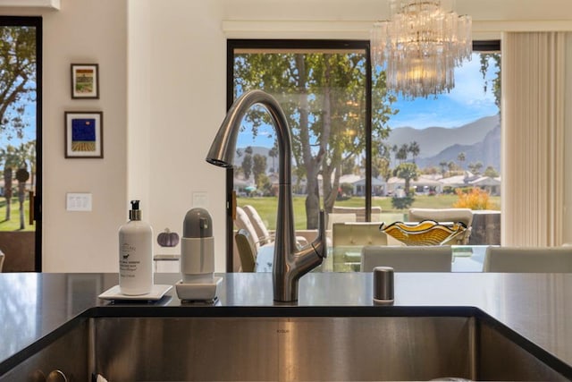 room details with a notable chandelier, a mountain view, and sink