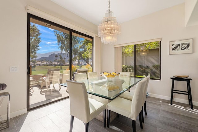 dining area featuring an inviting chandelier, a mountain view, and tile patterned flooring