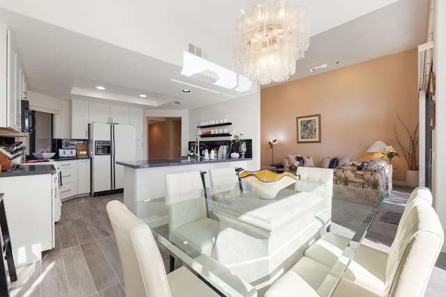 dining room with an inviting chandelier and a tray ceiling