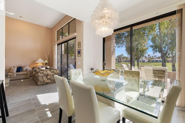 dining space featuring a chandelier and light carpet