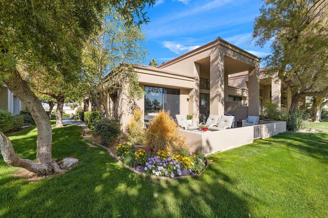 back of property featuring a lawn and a patio area