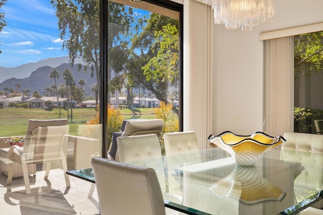 dining space featuring an inviting chandelier, a mountain view, and a wealth of natural light