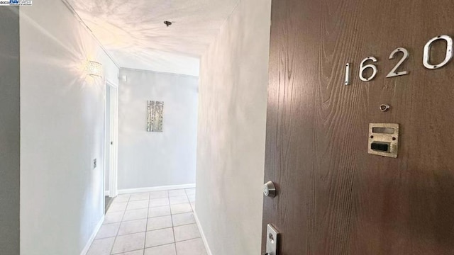 hall with light tile patterned floors