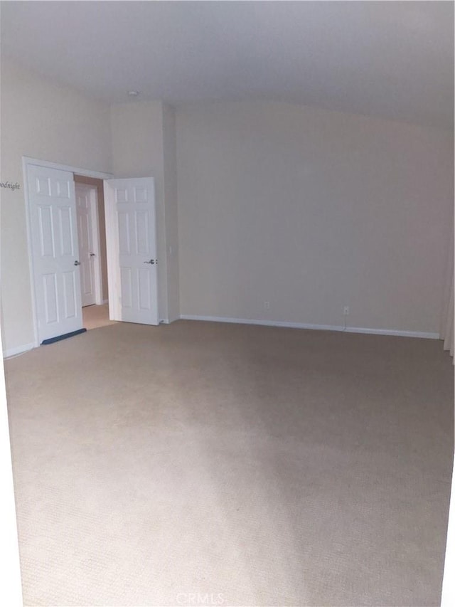 empty room with light carpet and baseboards