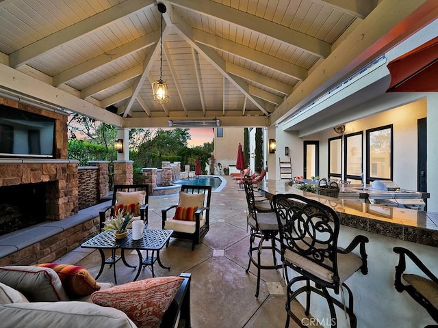 patio terrace at dusk with an outdoor bar and a gazebo