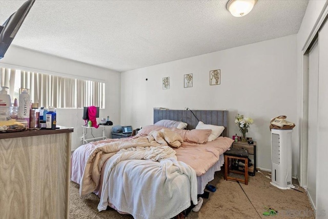 bedroom with carpet floors and a textured ceiling